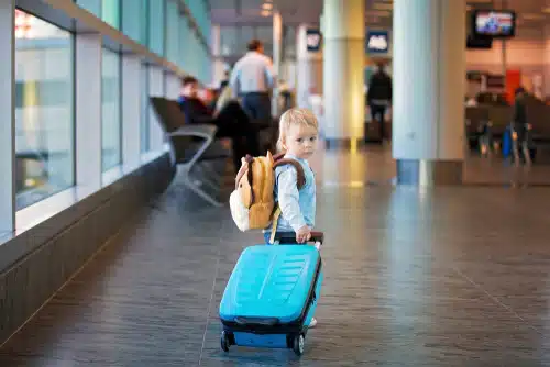 child flying from airport